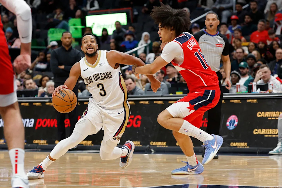 Jan 5, 2025; Washington, District of Columbia, USA; New Orleans Pelicans guard CJ McCollum (3) drives to the basket as Washington Wizards forward Kyshawn George (18) defends in the fourth quarter at Capital One Arena. Mandatory Credit: Geoff Burke-Imagn Images