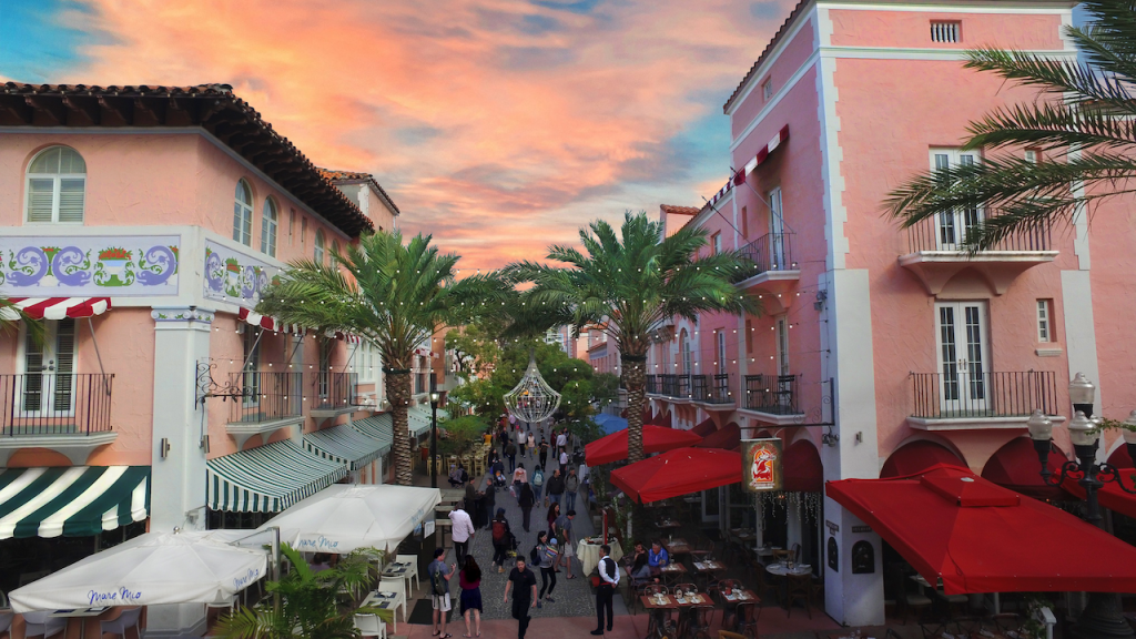 overhead view of a pedestrian thoroughfare between two pink buildings