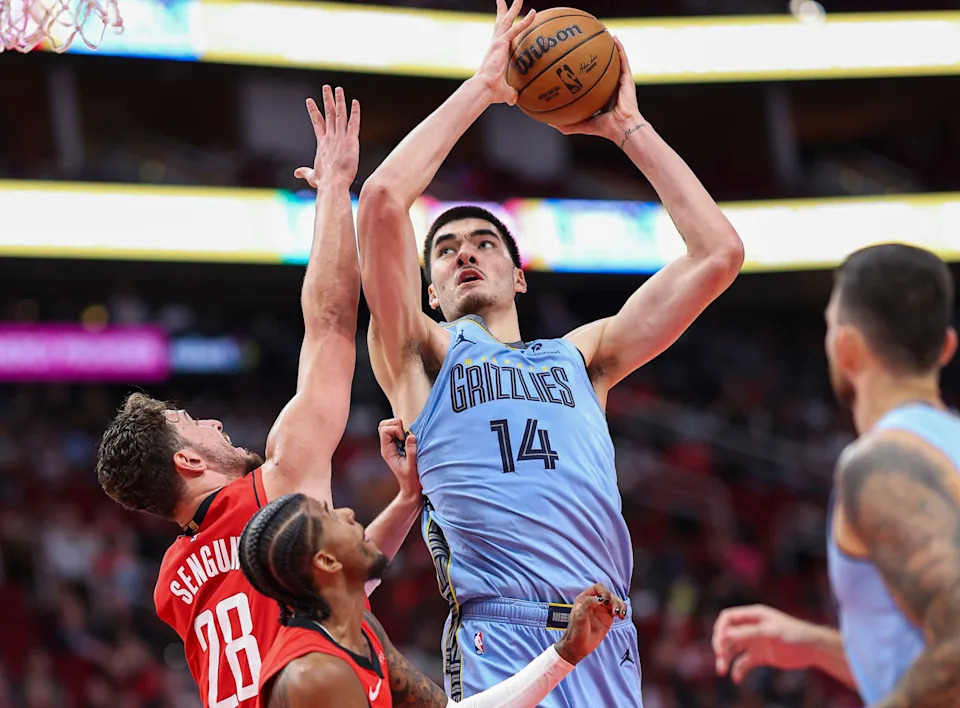Oct 25, 2024; Houston, Texas, USA; Memphis Grizzlies center Zach Edey (14) shoots the ball over Houston Rockets center Alperen Sengun (28) during the second quarter at Toyota Center. Mandatory Credit: Troy Taormina-Imagn Images