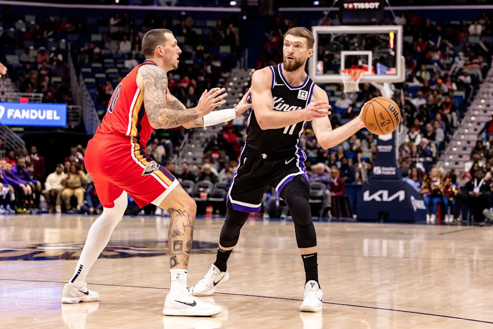 Dec 12, 2024; New Orleans, Louisiana, USA; Sacramento Kings forward Domantas Sabonis (11) dribbles against New Orleans Pelicans center Daniel Theis (10) during the second half at Smoothie King Center. Mandatory Credit: Stephen Lew-Imagn Images