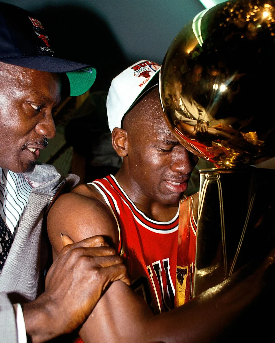 Michael Jordan celebrates with the trophy in front of his father, James, after the Chicago Bulls defeated the Los Angeles Lakers in the 1991 NBA Finals.