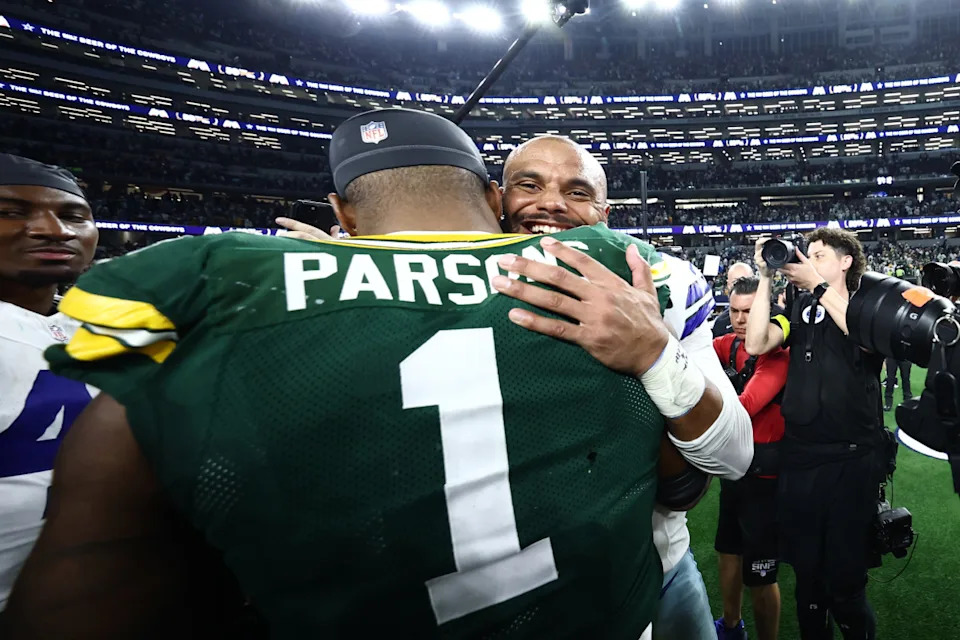 Sep 28, 2025; Arlington, Texas, USA; Green Bay Packers defensive end Micah Parsons (1) and Dallas Cowboys quarterback Dak Prescott (4) embrace after the tie game at AT&T Stadium. Mandatory Credit: Kevin Jairaj-Imagn Images© Kevin Jairaj-Imagn Images