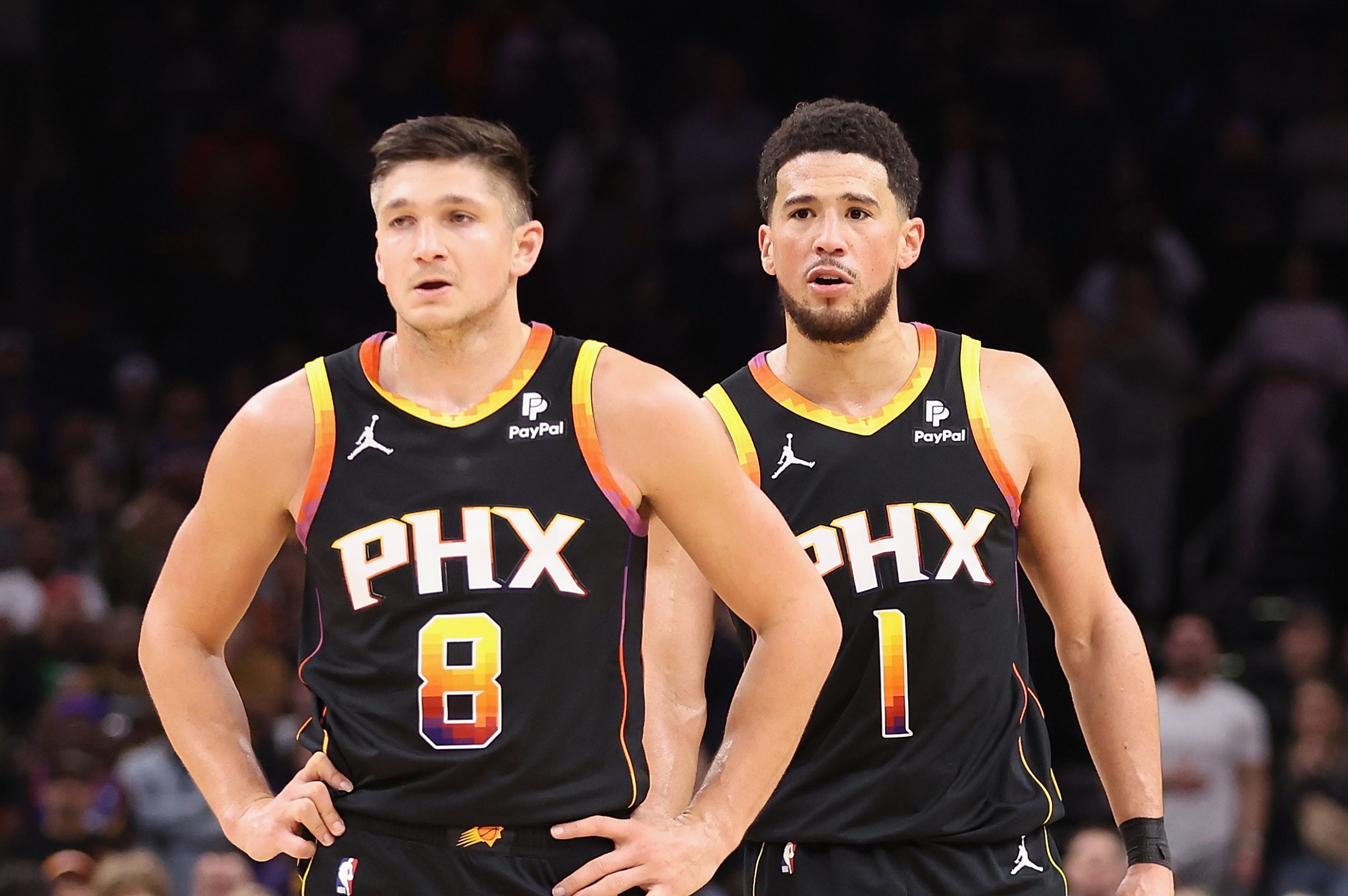 PHOENIX, ARIZONA - JANUARY 16: Grayson Allen #8 and Devin Booker #1 of the Phoenix Suns during the second half of the NBA game at Footprint Center on January 16, 2024 in Phoenix, Arizona. The Suns defeated the Kings 119-117. NOTE TO USER: User expressly acknowledges and agrees that, by downloading and or using this photograph, User is consenting to the terms and conditions of the Getty Images License Agreement. (Photo by Christian Petersen/Getty Images)