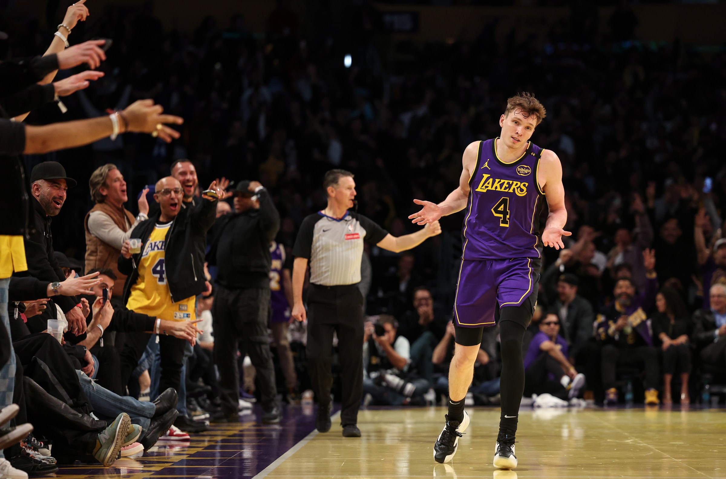 LOS ANGELES, CALIFORNIA - NOVEMBER 19: Dalton Knecht #4 of the Los Angeles Lakers reacts after scoring his fourth consecutive 3-point basket against the Utah Jazz during the third quarter of the Emirates NBA Cup at Crypto.com Arena on November 19, 2024 in Los Angeles, California. NOTE TO USER: User expressly acknowledges and agrees that, by downloading and or using this photograph, User is consenting to the terms and conditions of the Getty Images License Agreement. (Photo by Harry How/Getty Images)