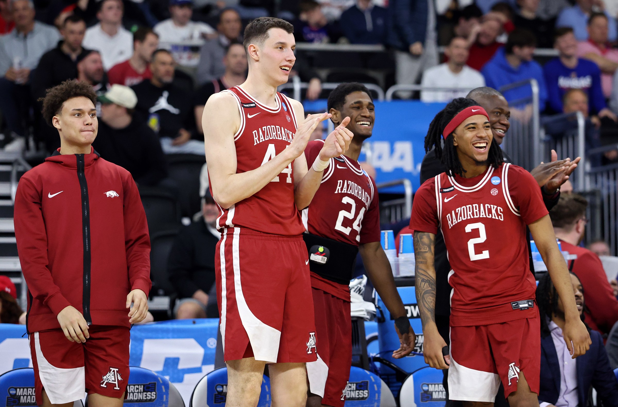 PROVIDENCE, RHODE ISLAND - MARCH 20: Zvonimir Ivisic #44, Billy Richmond III #24 and Boogie Fland #2 of the Arkansas Razorbacks celebrate on the bench during the second half in the first round of the NCAA Men’s Basketball Tournament against the Kansas Jayhawks at Amica Mutual Pavillion on March 20, 2025 in Providence, Rhode Island. (Photo by Emilee Chinn/Getty Images)