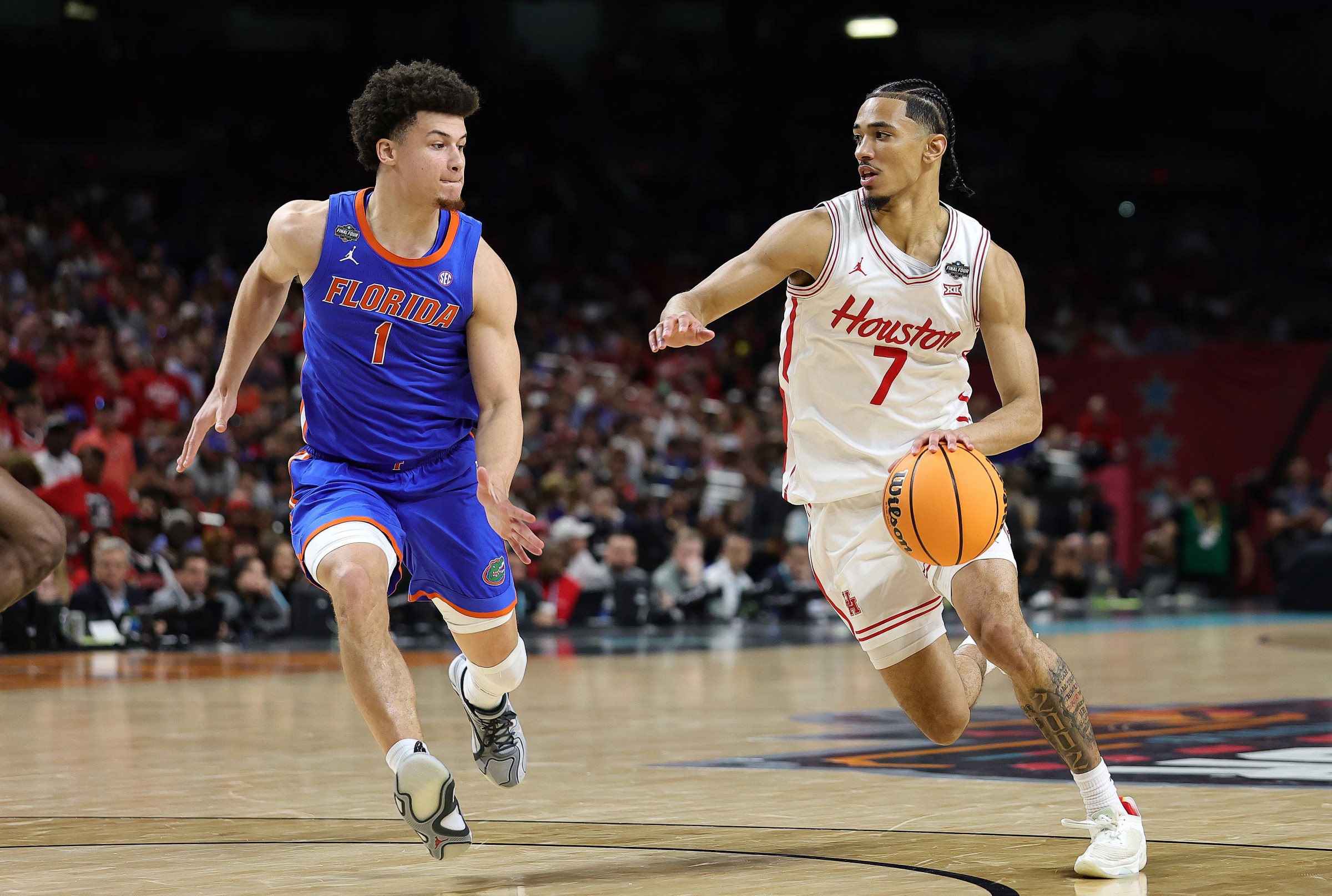 SAN ANTONIO, TEXAS - APRIL 07: Milos Uzan #7 of the Houston Cougars drives the ball against Walter Clayton Jr. #1 of the Florida Gators during the first half in the National Championship of the NCAA Men’s Basketball Tournament at the Alamodome on April 07, 2025 in San Antonio, Texas. (Photo by Alex Slitz/Getty Images)