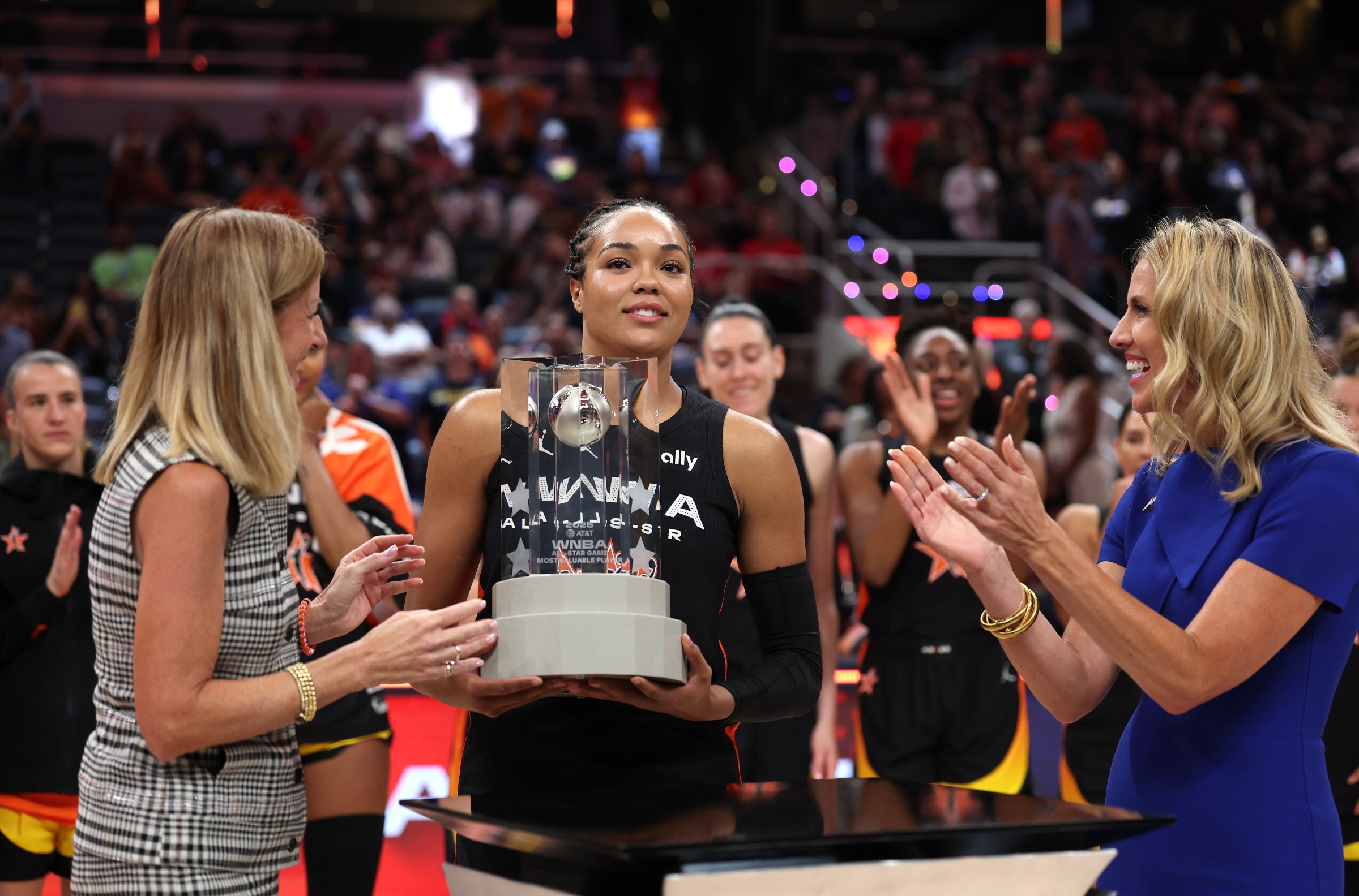 INDIANAPOLIS, INDIANA - JULY 19: Napheesa Collier #24 of the Minnesota Lynx (C) receives the MVP trophy from WNBA Commissioner Cathy Engelbert (L) following the 2025 AT&T WNBA All-Star Game at Gainbridge Fieldhouse on July 19, 2025 in Indianapolis, Indiana. NOTE TO USER: User expressly acknowledges and agrees that, by downloading and or using this photograph, User is consenting to the terms and conditions of the Getty Images License Agreement. (Photo by Steph Chambers/Getty Images)