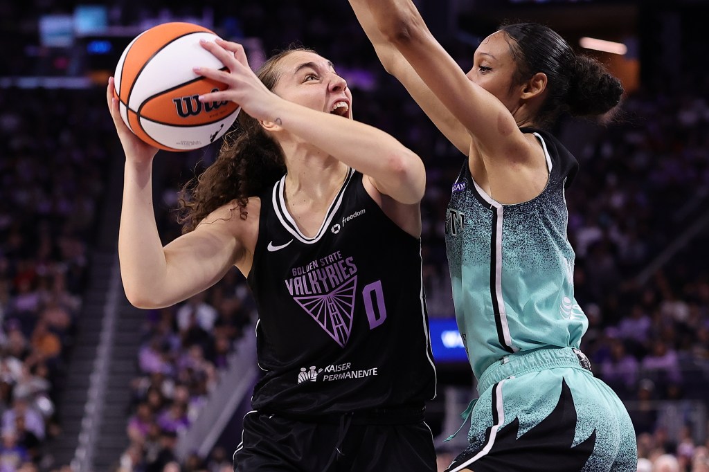 WNBA game: Golden State Valkyries player shooting over a New York Liberty player.