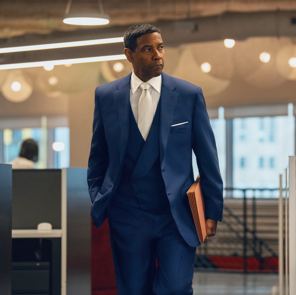 business professional in a suit walking through an office environment