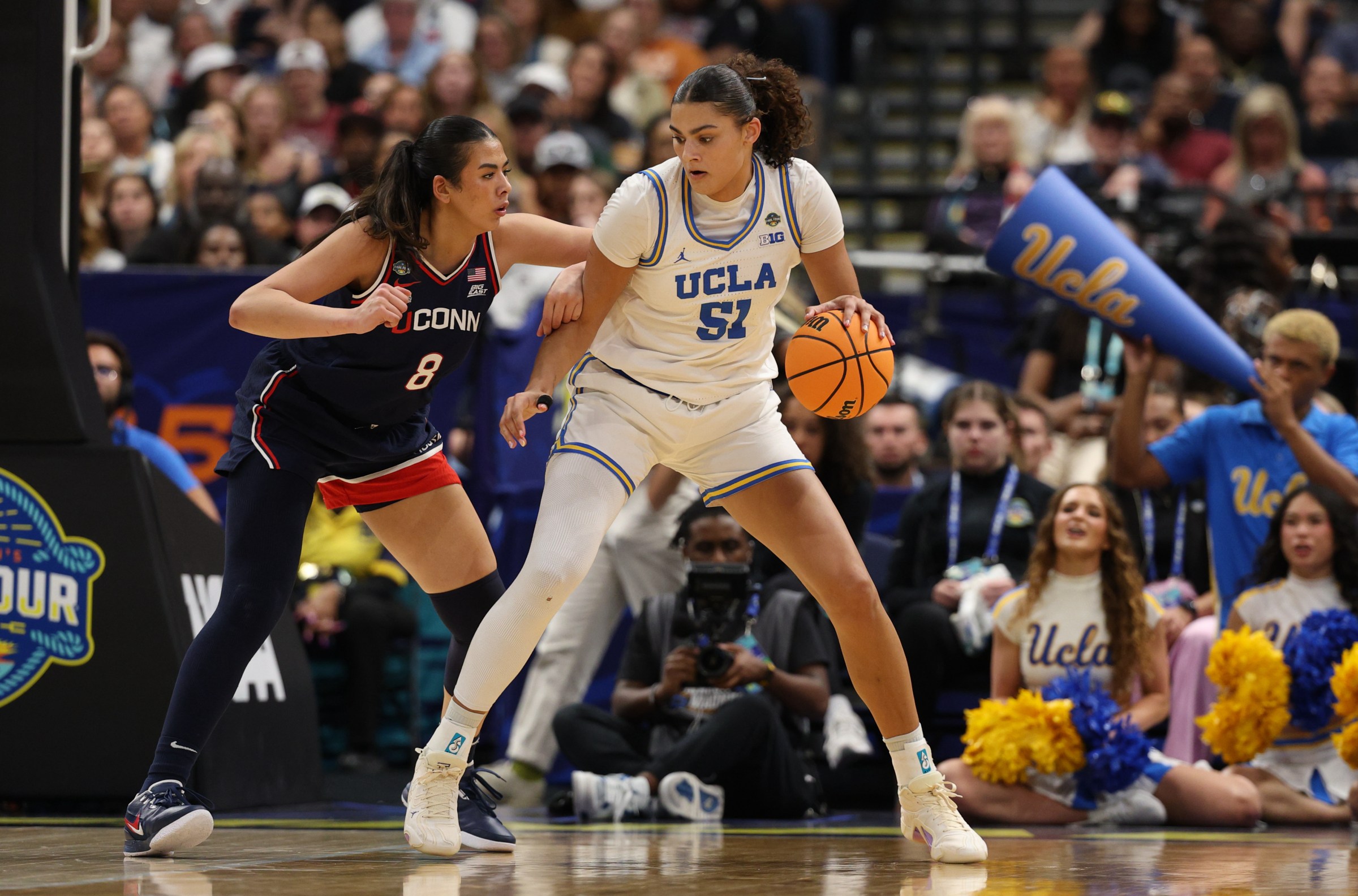 Apr 4, 2025; Tampa, FL, USA; UCLA Bruins center Lauren Betts (51) dribbles against Connecticut Huskies center Jana El Alfy (8) during the third quarter in a semifinal of the women’s 2025 NCAA tournament at Amalie Arena. Mandatory Credit: Nathan Ray Seebeck-Imagn Images