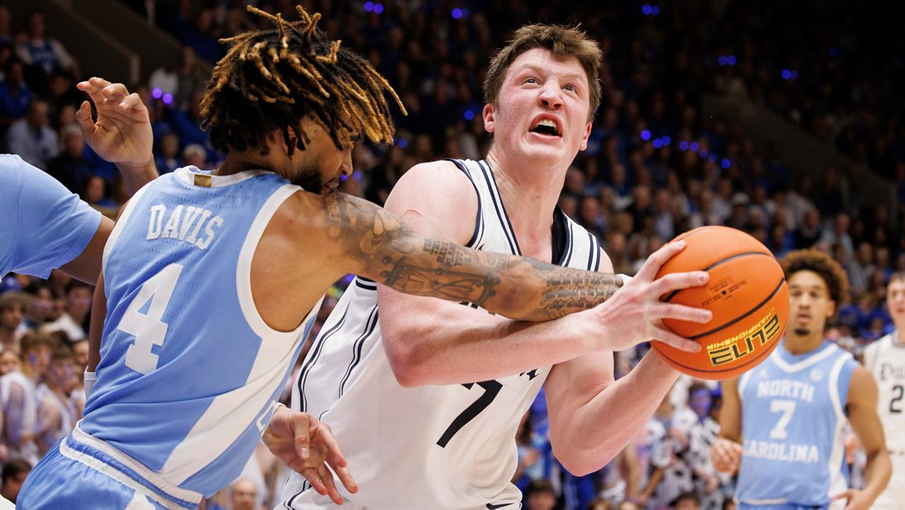 Duke's Kon Knueppel (7) drives as North Carolina's RJ Davis (4) defends during an NCAA college basketball game in Durham, N.C., Saturday, Feb. 1, 2025. (AP Photo/Ben McKeown)