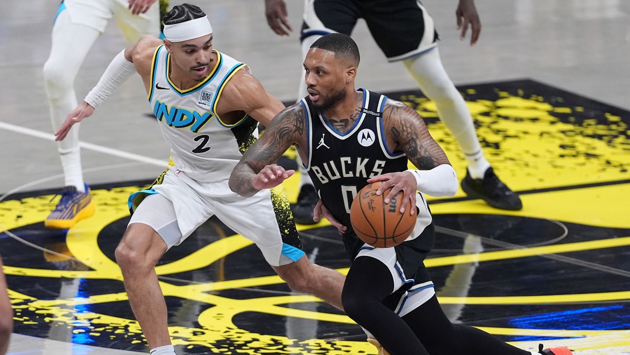 Milwaukee Bucks guard Damian Lillard (0) drives on Indiana Pacers guard Andrew Nembhard (2) during the first half of a first-round NBA basketball playoff game in Indianapolis, Tuesday, April 22, 2025.