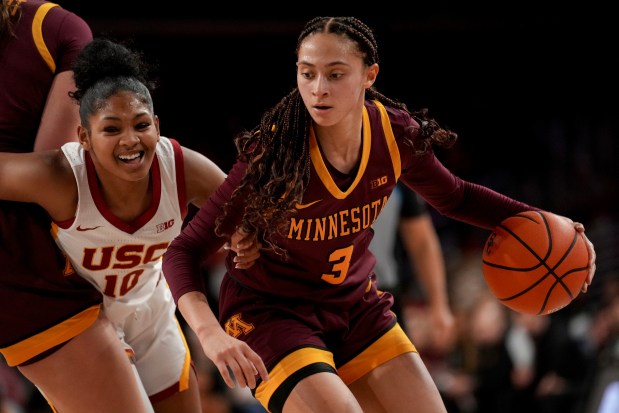 Minnesota guard Amaya Battle (3) dribbles against Southern California guard Malia Samuels (10) during the first half of an NCAA college basketball game in Los Angeles, Thursday, Jan. 30, 2025. (AP Photo/Eric Thayer)