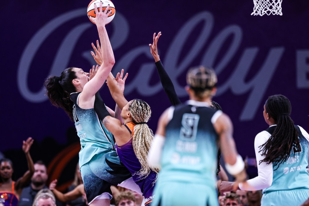 Breanna Stewart of the New York Liberty shooting over Satou Sabally of the Phoenix Mercury during a WNBA game.