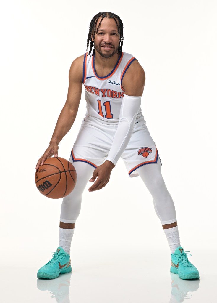 Jalen Brunson in a New York Knicks uniform, holding a basketball.