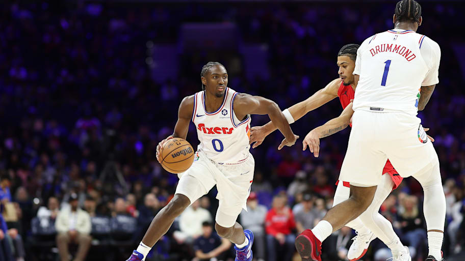 76ers guard Tyrese Maxey dribbles past Trail Blazers forward Toumani Camara.