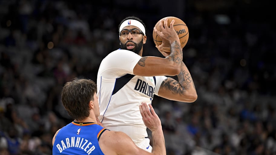 Mavericks forward/center Anthony Davis looks to move the ball past Thunder guard Brooks Barnhizer.
