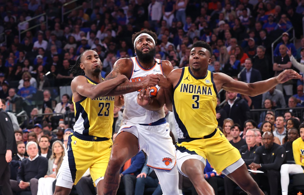 New York Knicks center Mitchell Robinson #23 fights with Indiana Pacers forward Aaron Nesmith #23 and Indiana Pacers center Thomas Bryant #3 for a rebound during the first quarter.