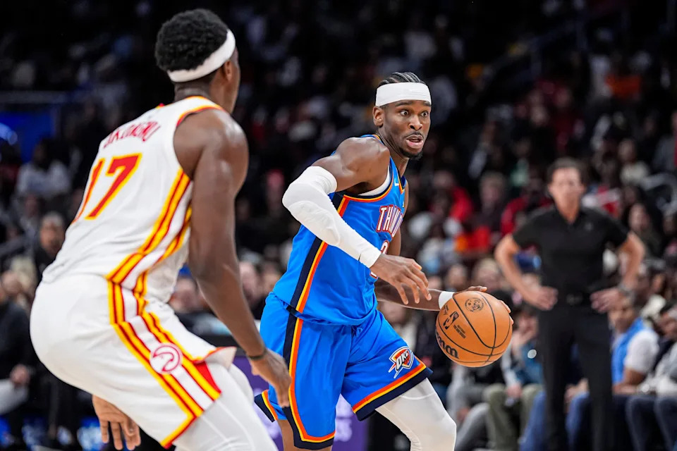Oct 25, 2025; Atlanta, Georgia, USA; Oklahoma City Thunder guard Shai Gilgeous-Alexander (2) dribbles against Atlanta Hawks forward Onyeka Okongwu (17) during the second half at State Farm Arena. Mandatory Credit: Dale Zanine-Imagn Images