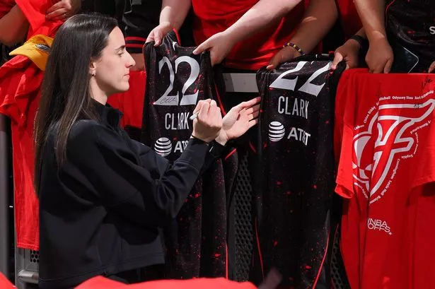 Caitlin Clark signs autographs before a game against the Las Vegas Aces