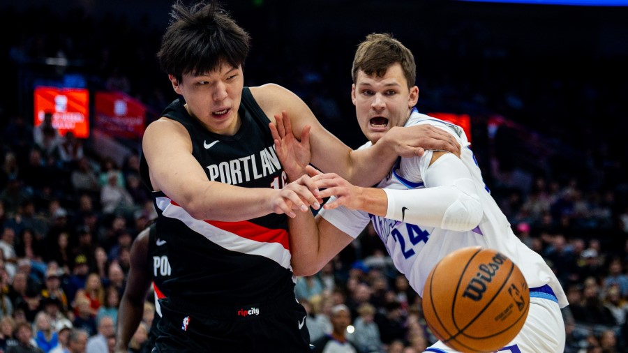 Portland Trail Blazers center Yang Hansen (16) and Utah Jazz center Walker Kessler (24)...