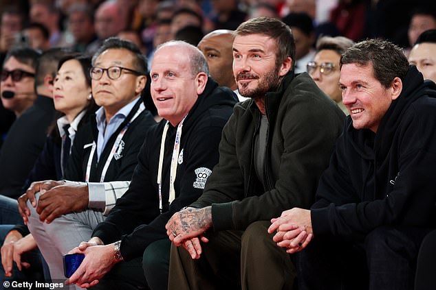 The former footballer, 50, beamed as he watched the second preseason game between the Brooklyn Nets and the Phoenix Suns, after attending Friday's match alongside Jackie Chan