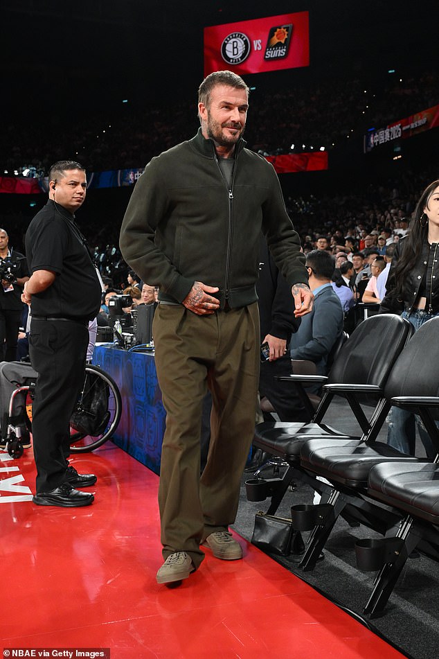 David cut a typically handsome figure in a forest green bomber jacket over a coordinating plain T-shirt and khaki trousers