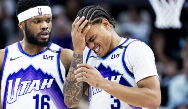 Utah Jazz guard Keyonte George (3) is helped off the court by guard Elijah Harkless (16) after Geor...
