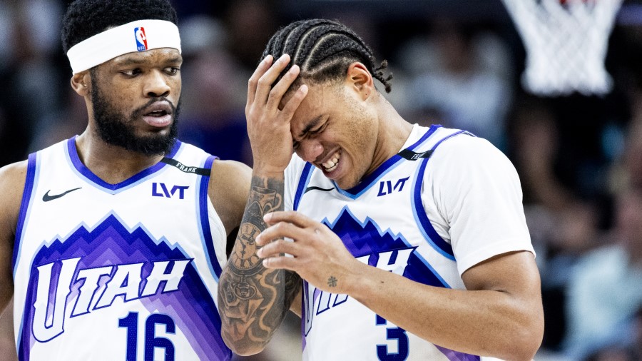 Utah Jazz guard Keyonte George (3) is helped off the court by guard Elijah Harkless (16) after Geor...