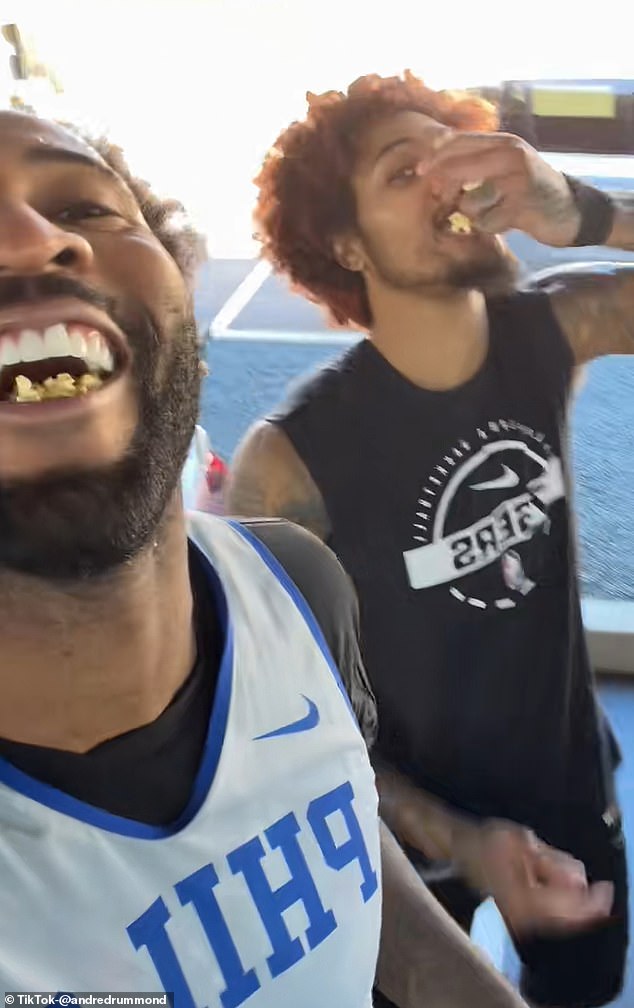 Andre Drummond and Kelly Oubre gleefully scooped up some popcorn from Bona's car