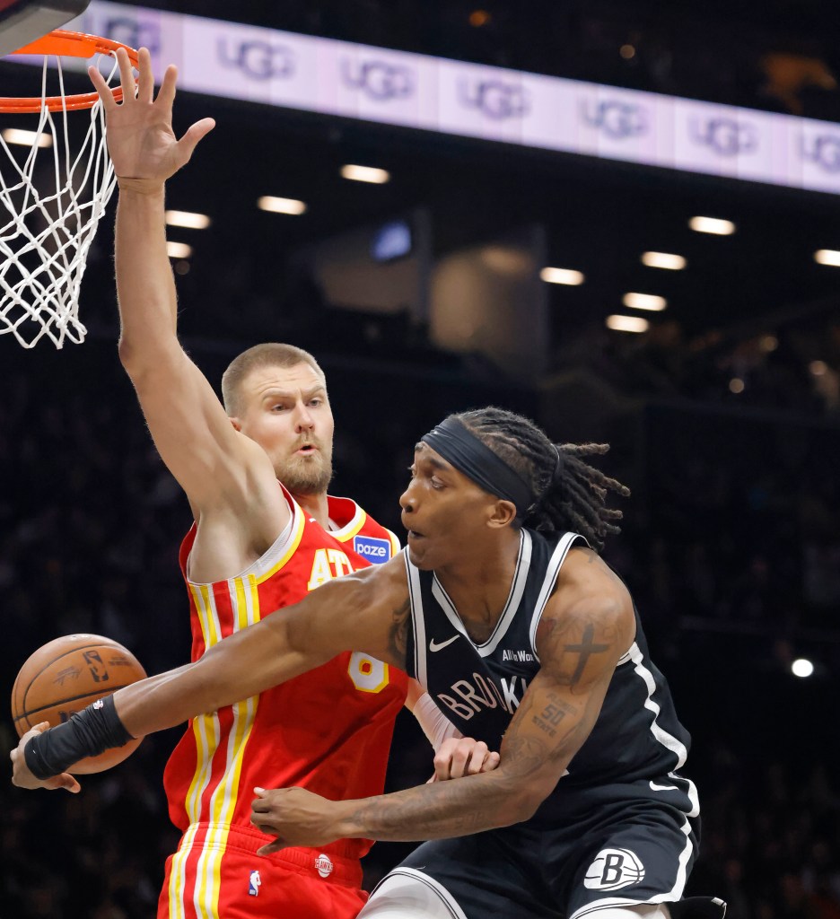 Terance Mann #14 of the Brooklyn Nets pass the ball around the back of Kristaps Porzingis #8 of the Atlanta Hawks during the first half when the Brooklyn Nets played the Atlanta Hawks Wednesday, October 29, 2025 at Barclays Center in Brooklyn, NY. 