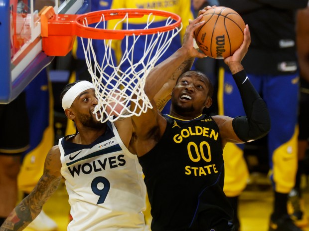 Golden State Warriors' Jonathan Kuminga (00) tries to get a shot off against Minnesota Timberwolves' Nickeil Alexander-Walker (9) in the second quarter of Game 4 of the Western Conference Second Round NBA Playoffs at the Chase Center in San Francisco, Calif., on Monday, May 12, 2025. (Nhat V. Meyer/Bay Area News Group)