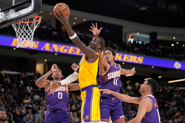The Lakers’ Deandre Ayton shoots as, from left, Phoenix’s Ryan...