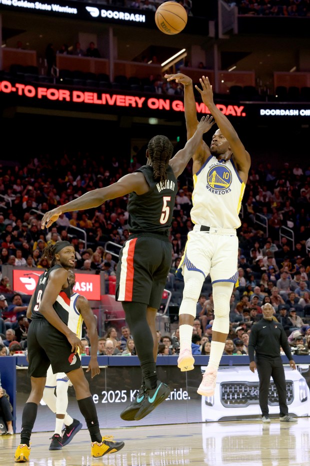 Golden State Warriors' Jimmy Butler III (10) lays up a shot against Portland Trail Blazers' Jrue Holiday (5) in the second quarter of an NBA preseason game at Chase Center in San Francisco, Calif., on Wednesday, Oct. 8, 2025. (Ray Chavez/Bay Area News Group)