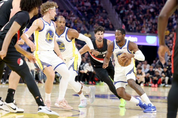 Golden State Warriors' Jonathan Kuminga (1) drives past Portland Trail Blazers' Deni Avdija (8) as Golden State Warriors' Brandin Podziemski (2) and Golden State Warriors' Al Horford (20) move over in the second quarter of an NBA preseason game at Chase Center in San Francisco, Calif., on Wednesday, Oct. 8, 2025. (Ray Chavez/Bay Area News Group)