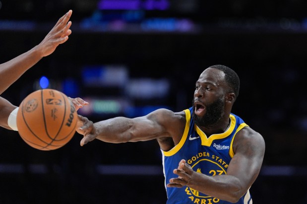 Golden State Warriors' Draymond Green passes the ball during the first half of a preseason NBA basketball game against the Los Angeles Lakers Sunday, Oct. 12, 2025, in Los Angeles. (AP Photo/Jae C. Hong)