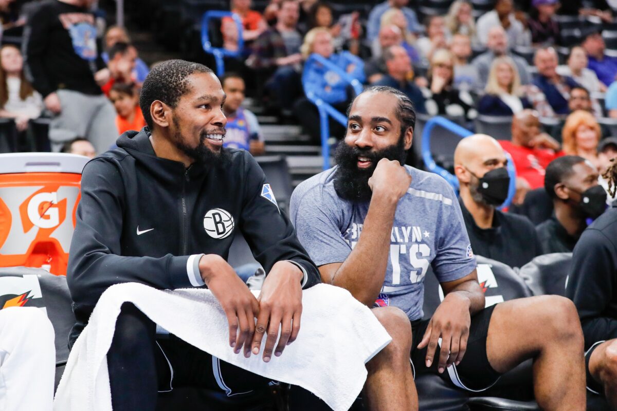 Brooklyn Nets forward Kevin Durant (7) and guard James Harden (13) talk on the bench during the fourth quarter at Paycom Center. Brooklyn won 120-96.