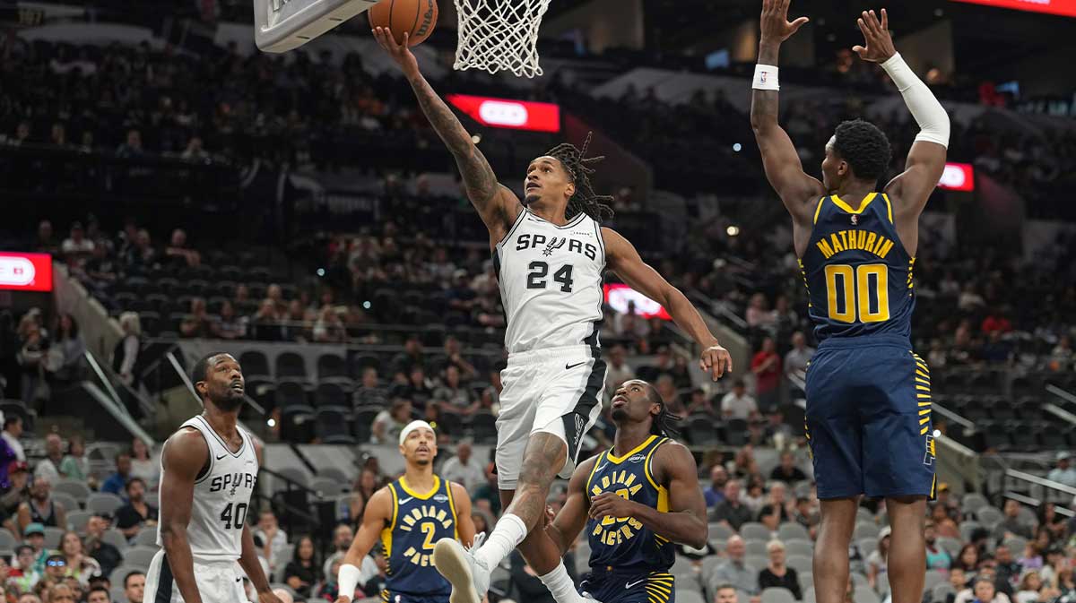 San Antonio Spurs guard Devin Vassell (24) drives to the basket against Indiana Pacers guard Bennedict Mathurin (00) during the first half at Frost Bank Center.