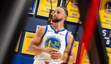 A San Francisco 49ers player wearing number 47 is being blocked by an Atlanta Falcons player while the Falcons quarterback, number 9, prepares to throw the ball.