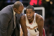 Cleveland Cavaliers' Damon Jones, right, is helped by trainer Max Benton after a minor...