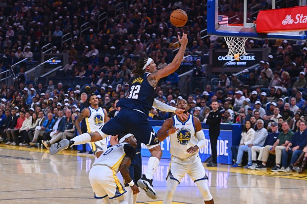 Denver Nuggets' Aaron Gordon (32) goes up for a basket over Golden State Warriors' Gary Payton II (0) in the second quarter of their NBA game at Chase Center in San Francisco, Calif., on Thursday, Oct. 23, 2025. (Jose Carlos Fajardo/Bay Area News Group)