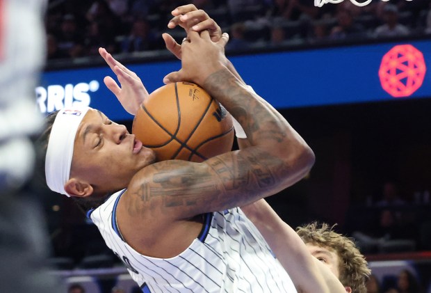 Orlando forward Paolo Banchero pulls down a rebound during the...