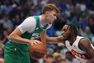 Dallas Mavericks forward Cooper Flagg, left, moves the ball against Toronto Raptors guard...