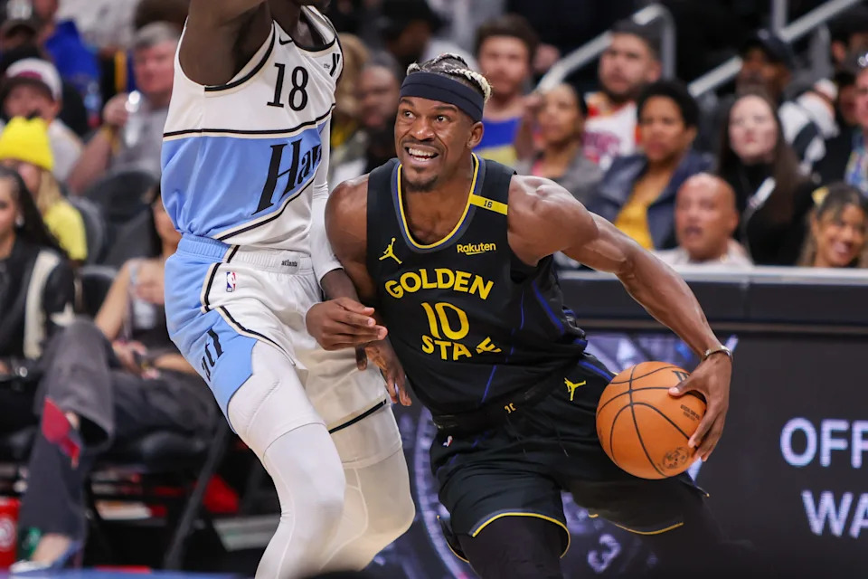 Mar 22, 2025; Atlanta, Georgia, USA; Golden State Warriors forward Jimmy Butler III (10) drives on Atlanta Hawks forward Mouhamed Gueye (18) in the third quarter at State Farm Arena. Mandatory Credit: Brett Davis-Imagn Images