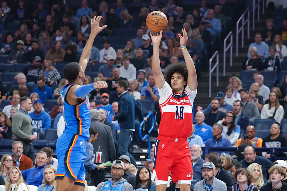 Oct 30, 2025; Oklahoma City, Oklahoma, USA; Washington Wizards forward Kyshawn George (18) shoots as Oklahoma City Thunder guard Aaron Wiggins (21) defends during the first quarter at Paycom Center. Mandatory Credit: Alonzo Adams-Imagn Images
