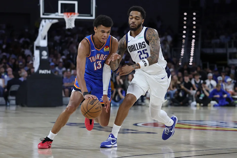 FORT WORTH, TEXAS - OCTOBER 06: Ousmane Dieng #13 of the Oklahoma City Thunder is defended by P.J. Washington #25 of the Dallas Mavericks during the first half of a preseason game at Dickies Arena on October 06, 2025 in Fort Worth, Texas. NOTE TO USER: User expressly acknowledges and agrees that, by downloading and or using this photograph, User is consenting to the terms and conditions of the Getty Images License Agreement. (Photo by Stacy Revere/Getty Images)