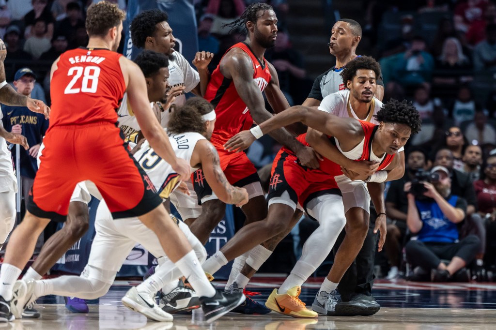 New Orleans Pelicans guard Jose Alvarado (15) and Houston Rockets guard-forward Amen Thompson (1) are pulled apart after a skirmish during an NBA preseason game at Legacy Arena at BJCC. 