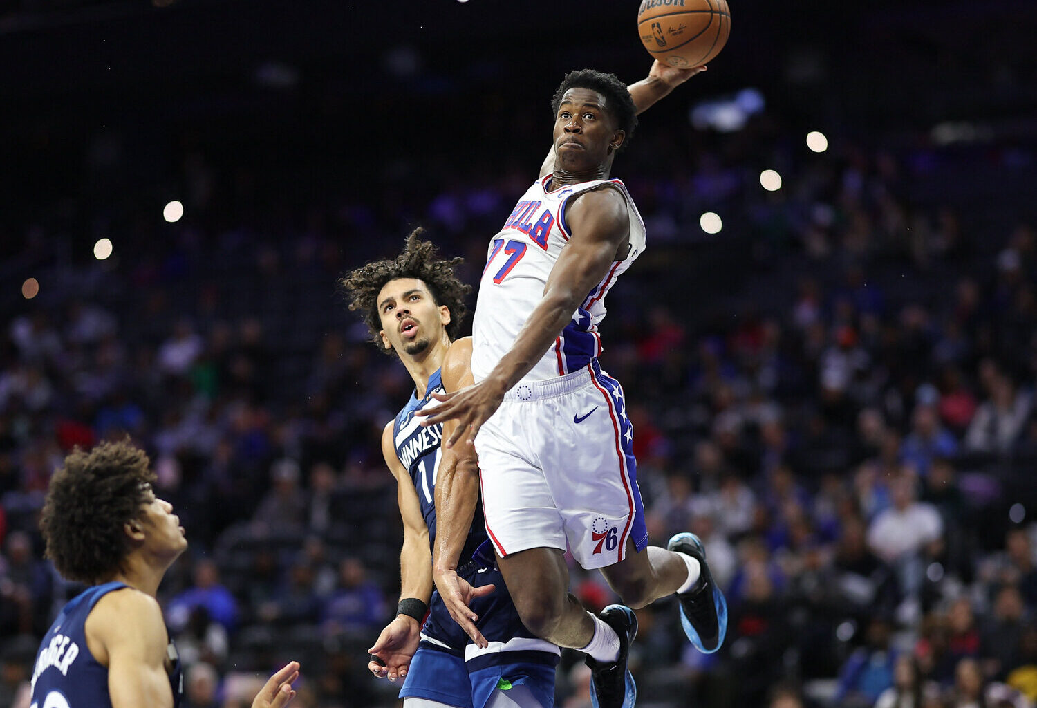 Oct 17, 2025; Philadelphia, Pennsylvania, USA; Philadelphia 76ers guard Vj Edgecombe (77) is fouled by Minnesota Timberwolves guard Jules Bernard (14) while driving for a dunk during the fourth quarter at Xfinity Mobile Arena. Mandatory Credit: Bill Streicher-Imagn Images