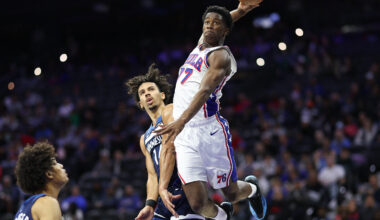 Oct 17, 2025; Philadelphia, Pennsylvania, USA; Philadelphia 76ers guard Vj Edgecombe (77) is fouled by Minnesota Timberwolves guard Jules Bernard (14) while driving for a dunk during the fourth quarter at Xfinity Mobile Arena. Mandatory Credit: Bill Streicher-Imagn Images