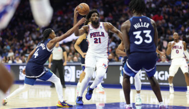 Philadelphia 76ers center Joel Embiid (21) drives the lane between Minnesota Timberwolves guard Rob Dillingham (4) and forward Leonard Miller (33) during the third quarter at Xfinity Mobile Arena.